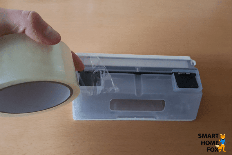 Taping off one of the emptying holes of the Ecovacs Deebot N8+.